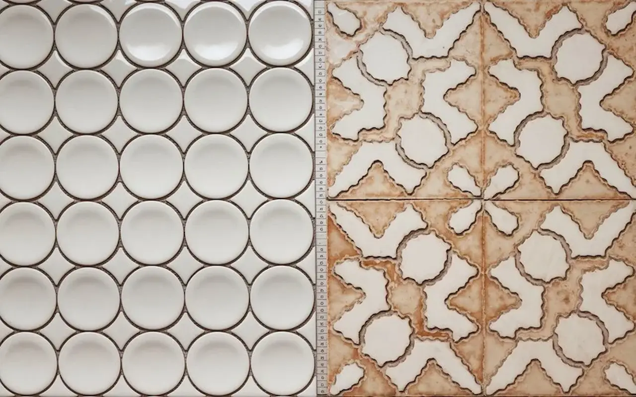 Sample display of round mosaic tiles and decorative patterned ceramic tiles.